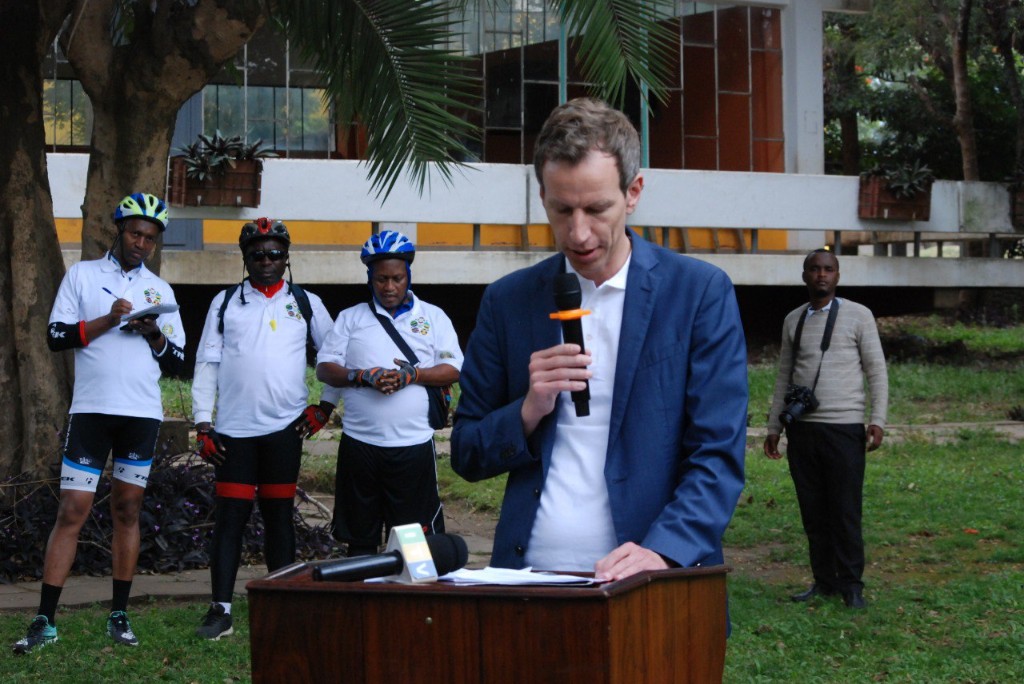 Official GACS launch with speaker at podium and expedition cyclists in attendance