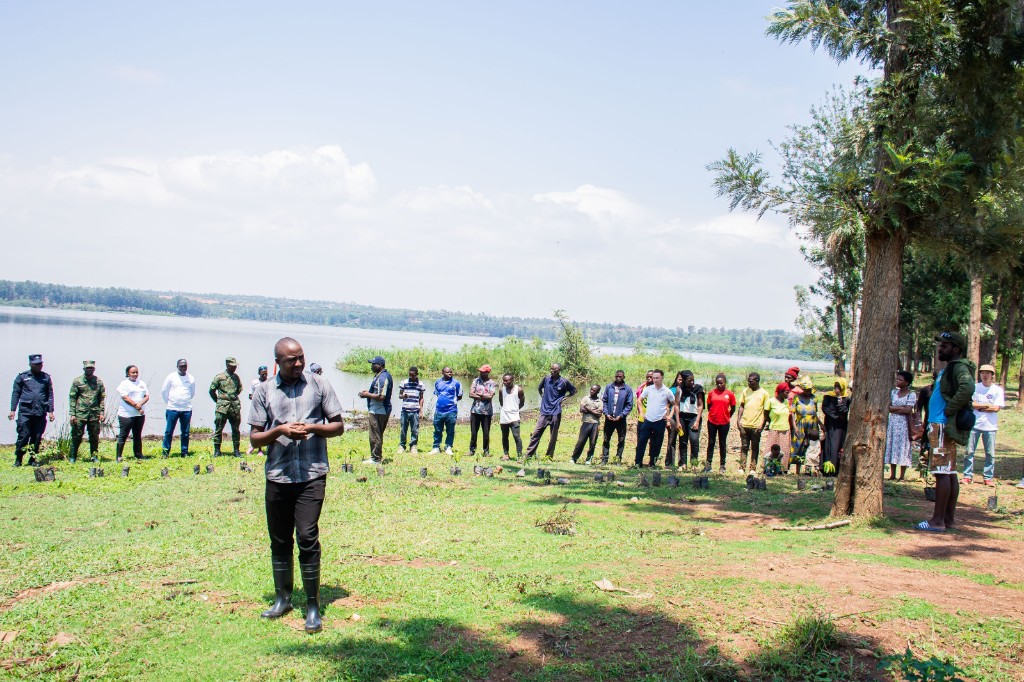 Community tree-planting initiative beside a lake with GACS participants and local residents